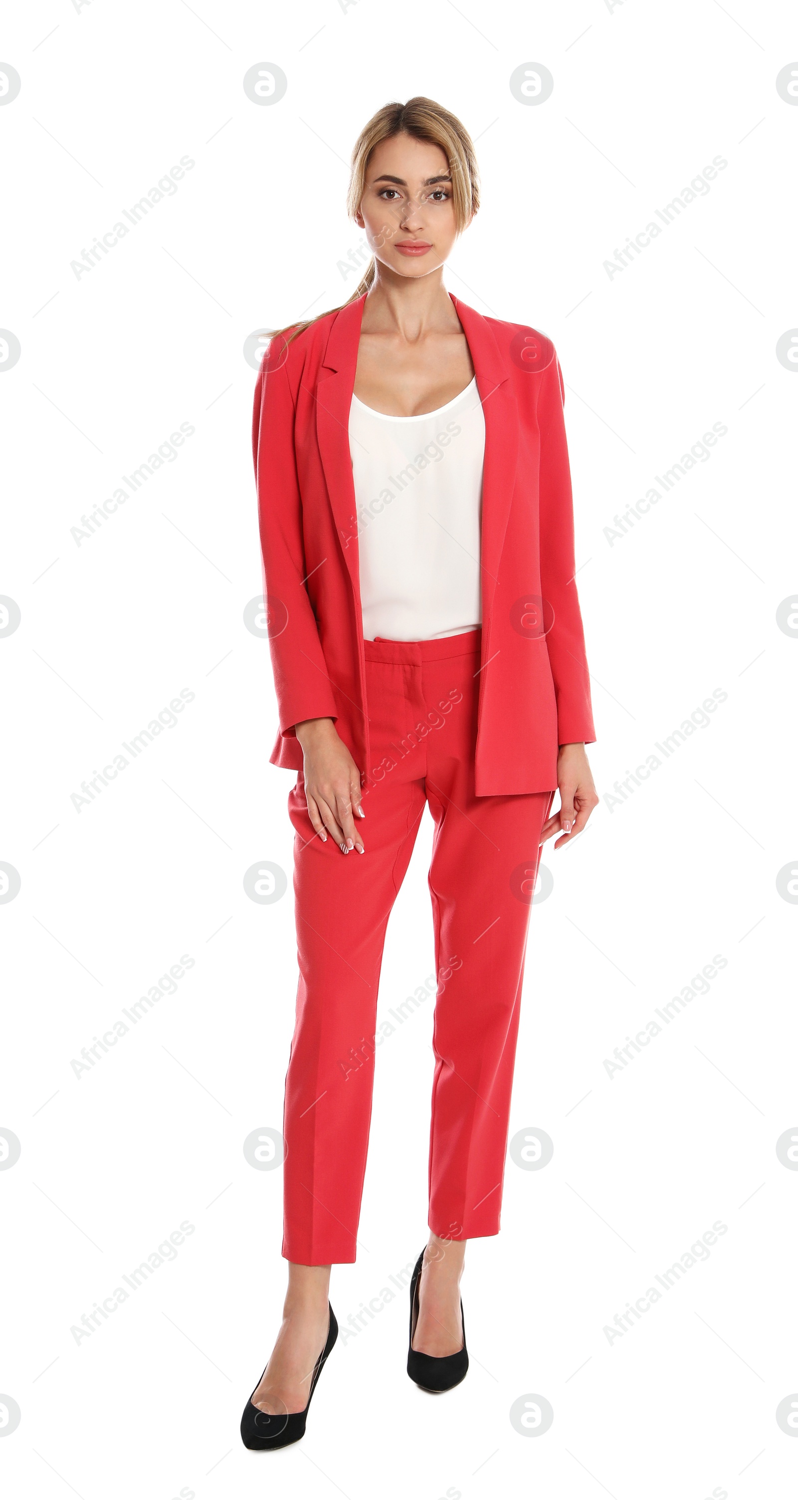 Photo of Beautiful young woman in red suit posing on white background