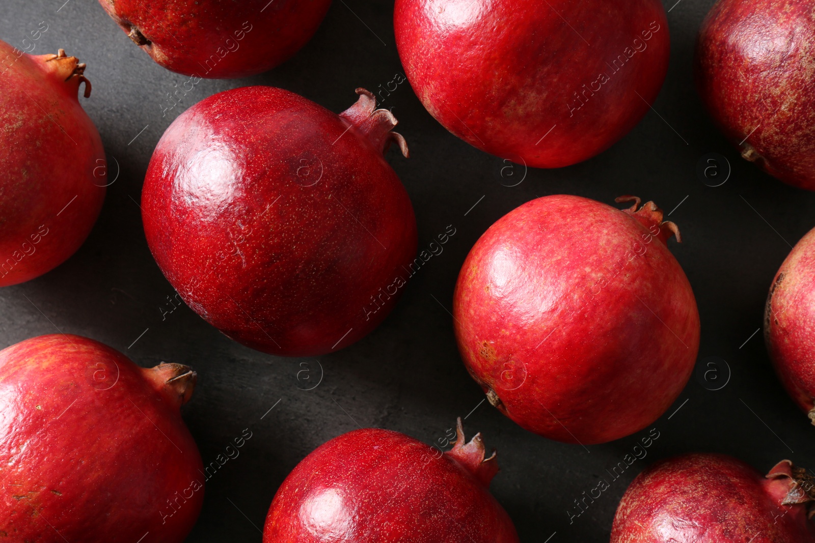 Photo of Flat lay composition with pomegranates on grey background