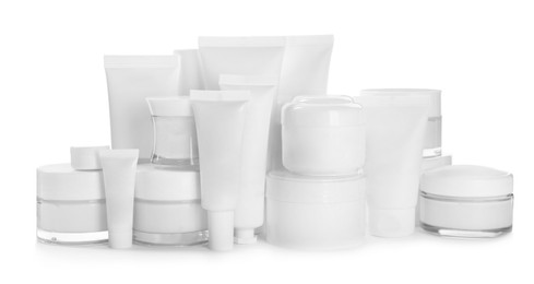 Photo of Blank tubes and jars of cosmetic products on white background