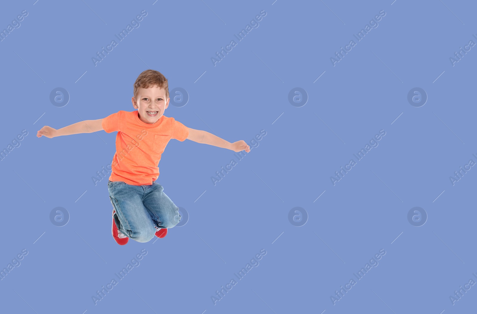 Image of Happy boy jumping on light blue background, space for text