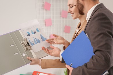 Businesspeople working with charts in office, closeup