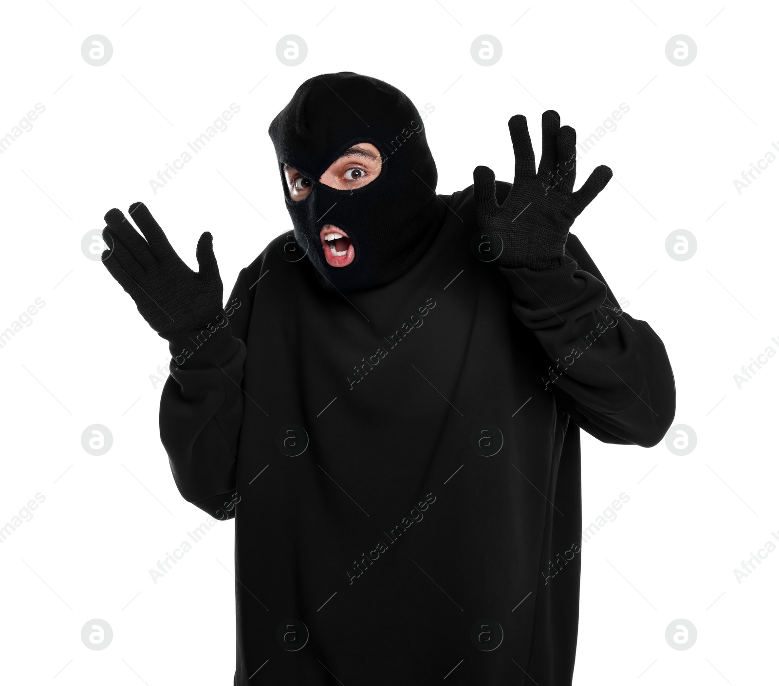 Photo of Emotional thief in balaclava raising hands on white background