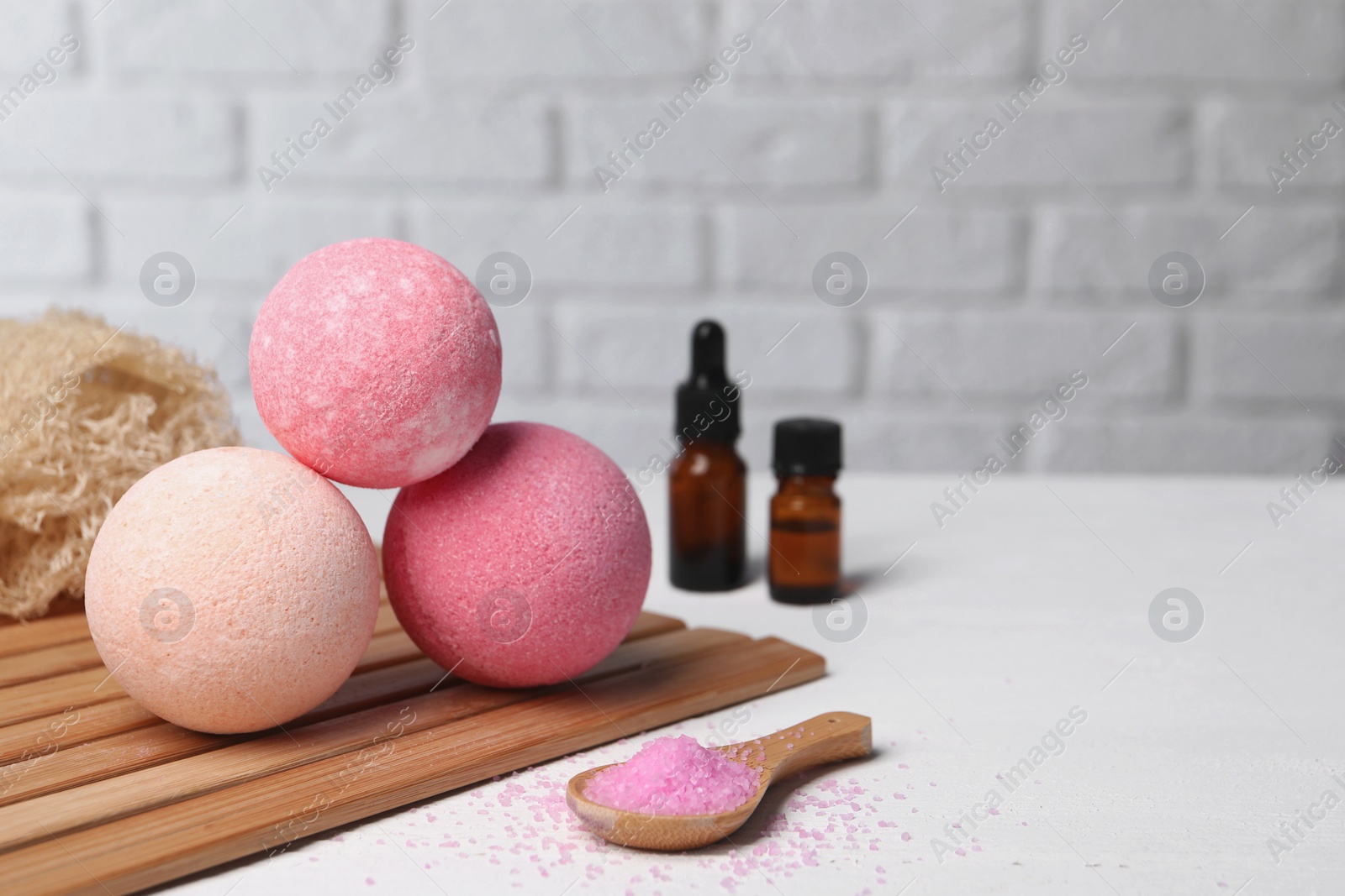 Photo of Beautiful composition with aromatic bath bombs on white table, space for text