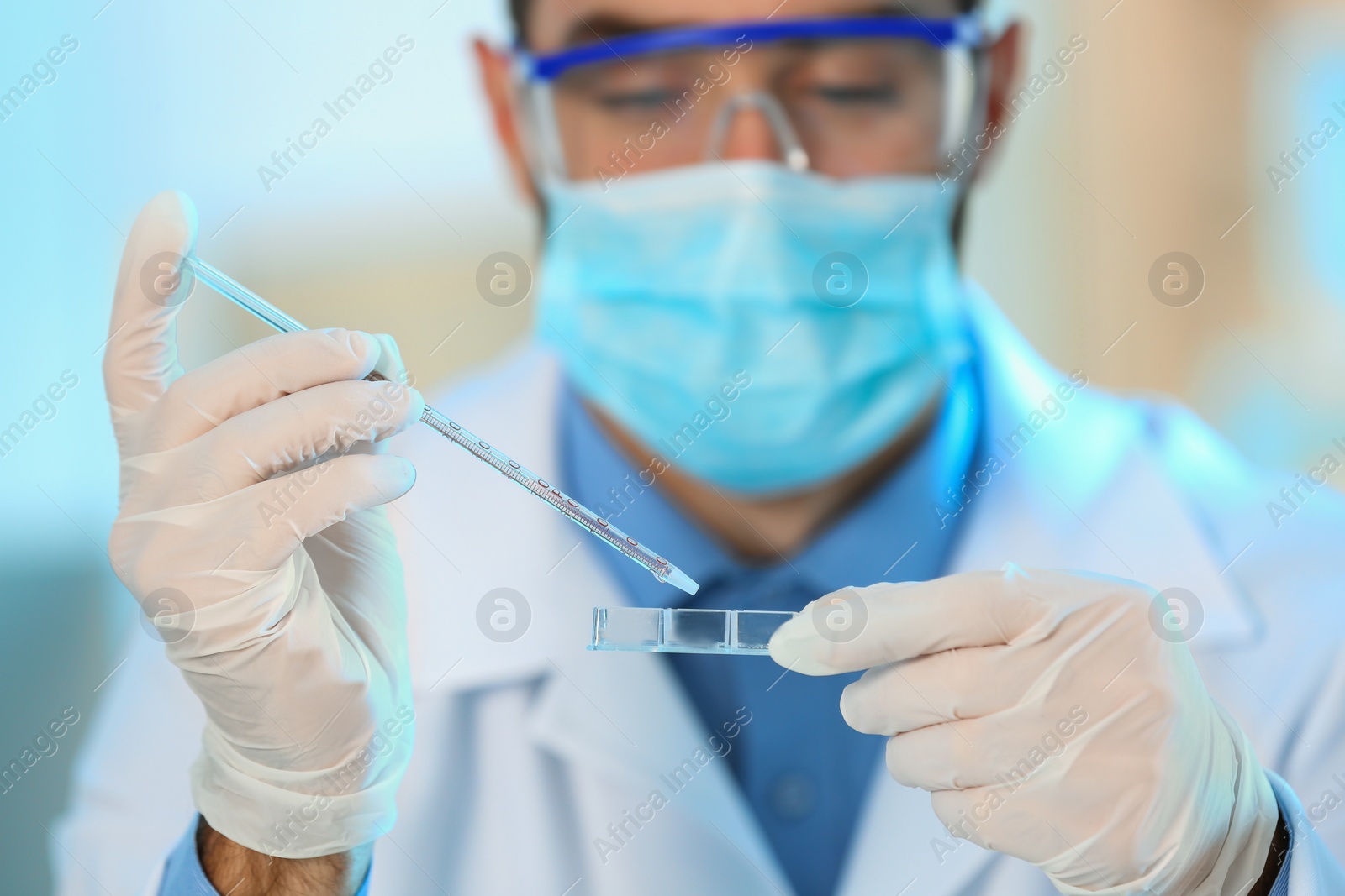 Photo of Young scientist working with fluid sample, closeup. Laboratory analysis