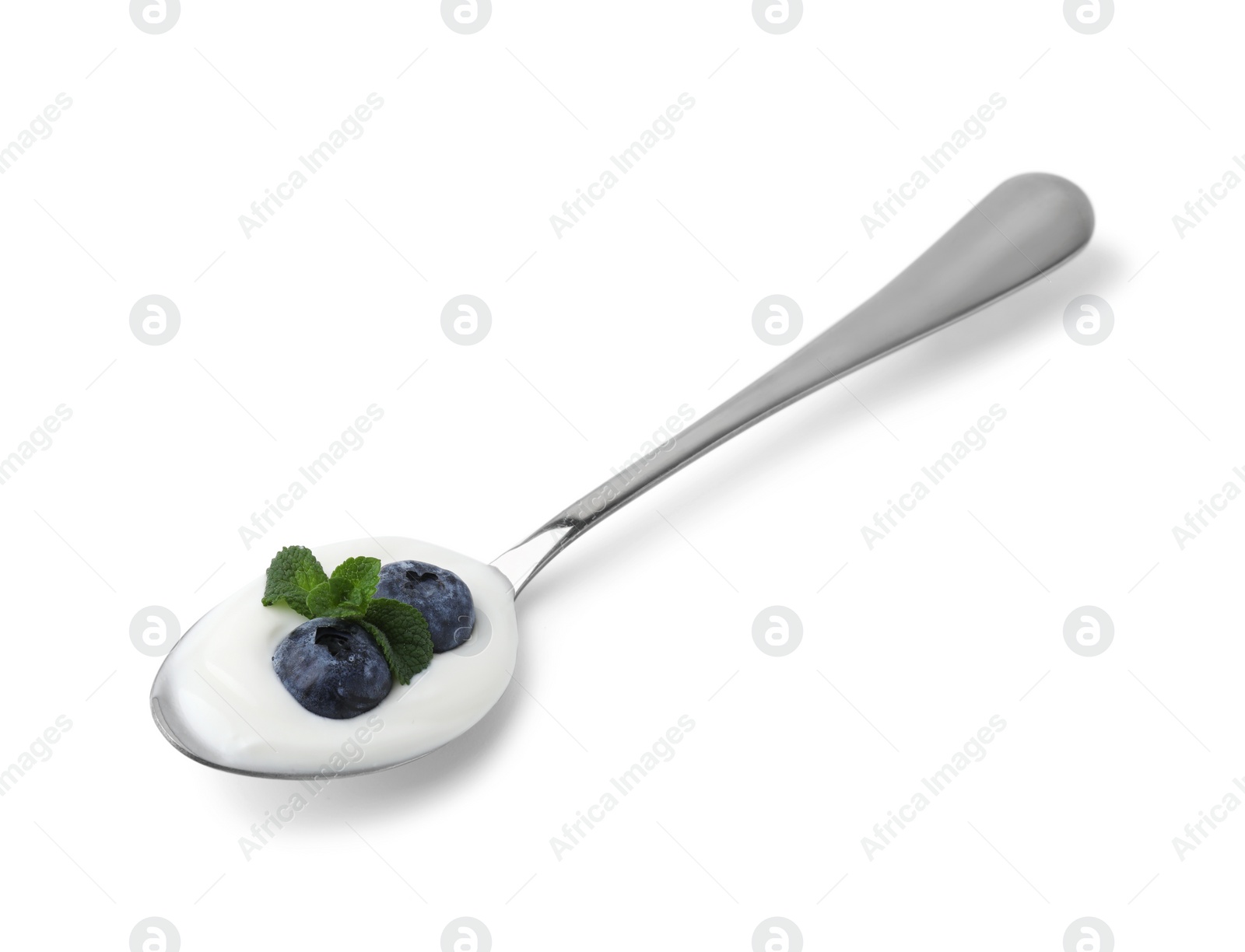 Photo of Spoon with yogurt, blueberries and mint isolated on white