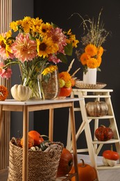 Photo of Room decorated with pumpkins and bright flowers. Autumn vibes