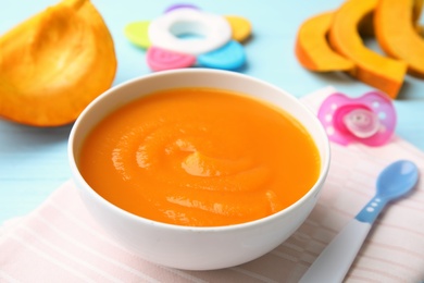 Photo of Bowl of healthy baby food on wooden table