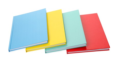 Photo of Different colorful hardcover planners on white background