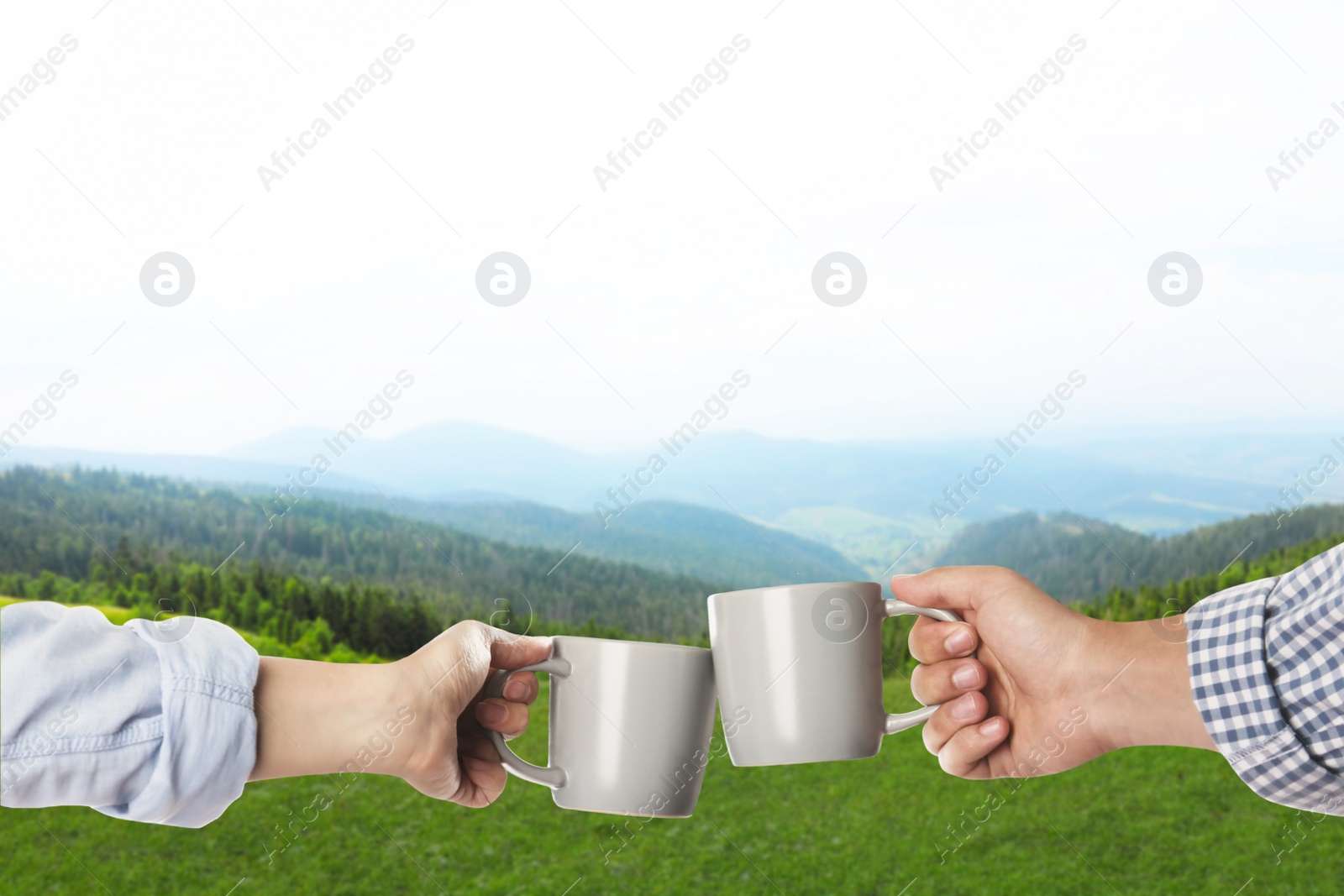 Image of Closeness to nature. Couple with cups in mountains, closeup