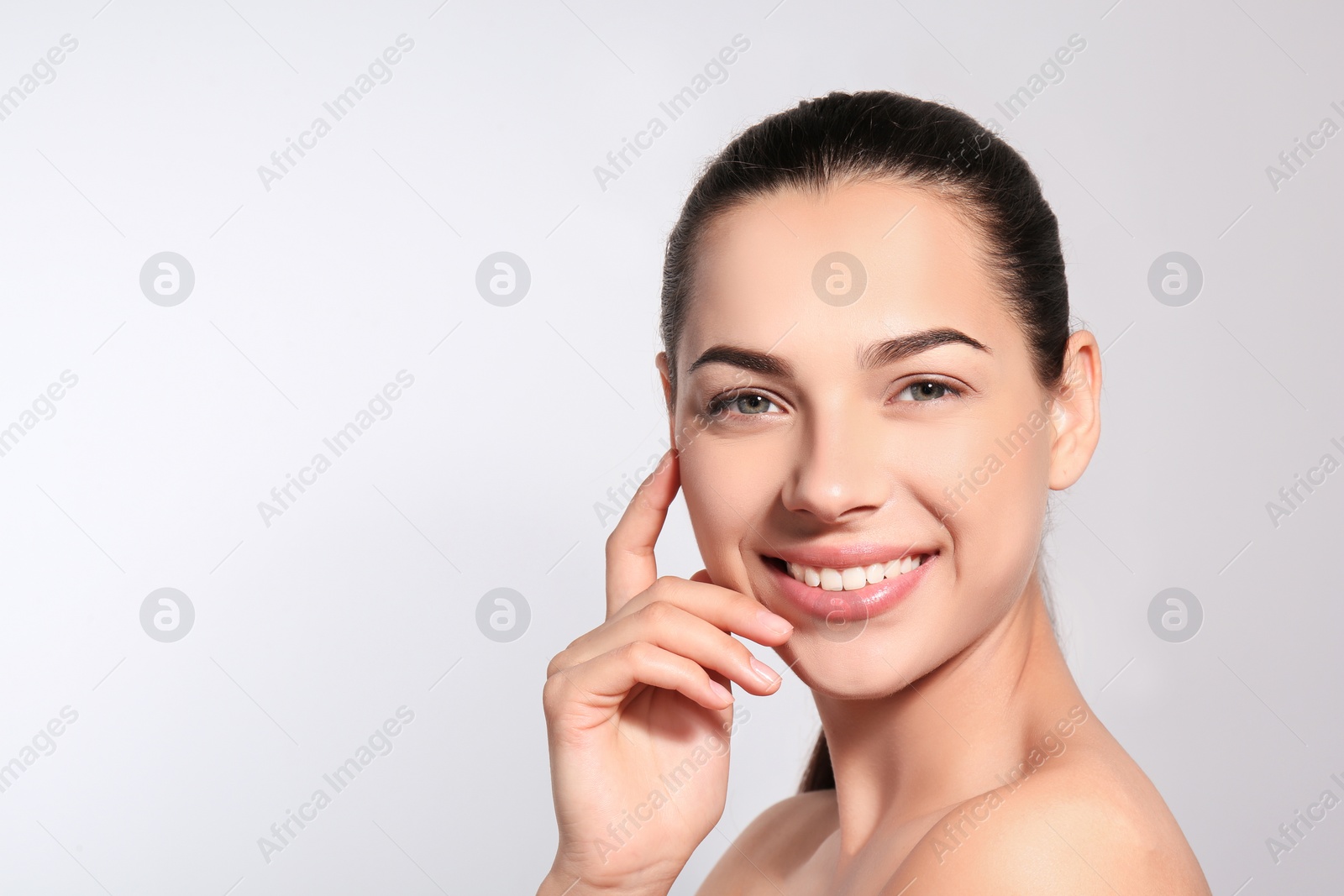 Photo of Beautiful woman with perfect eyebrows on light background