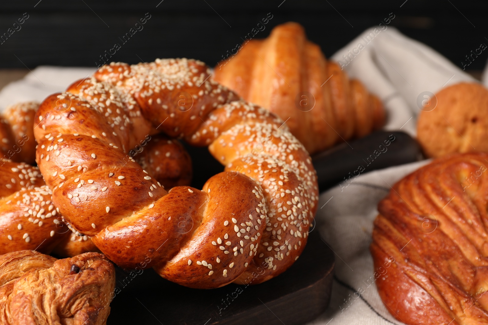 Photo of Different tasty freshly baked pastries on table, closeup