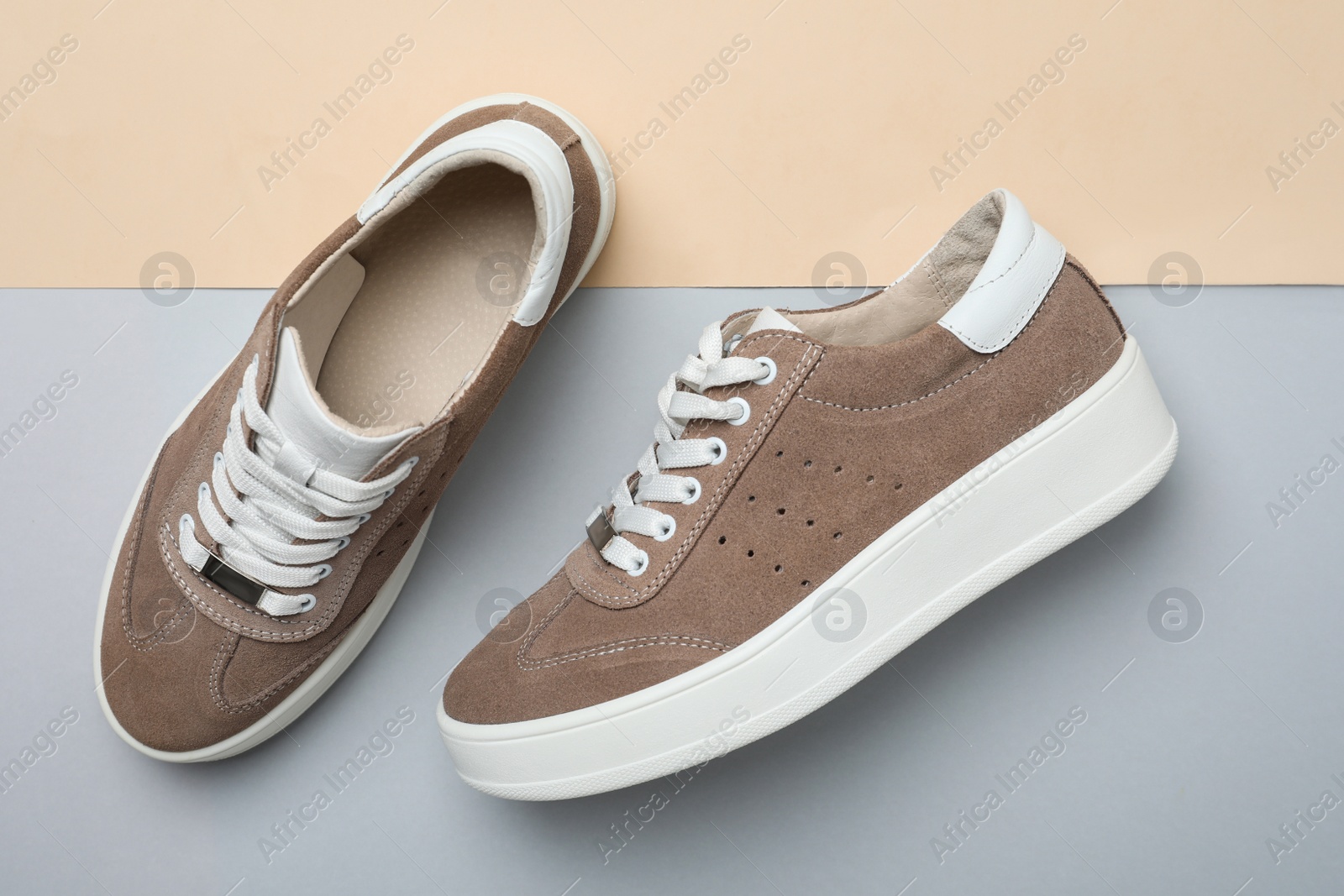 Photo of Stylish brown shoes on color background, flat lay