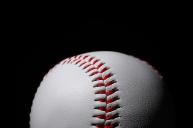 Photo of One baseball ball on black background, closeup