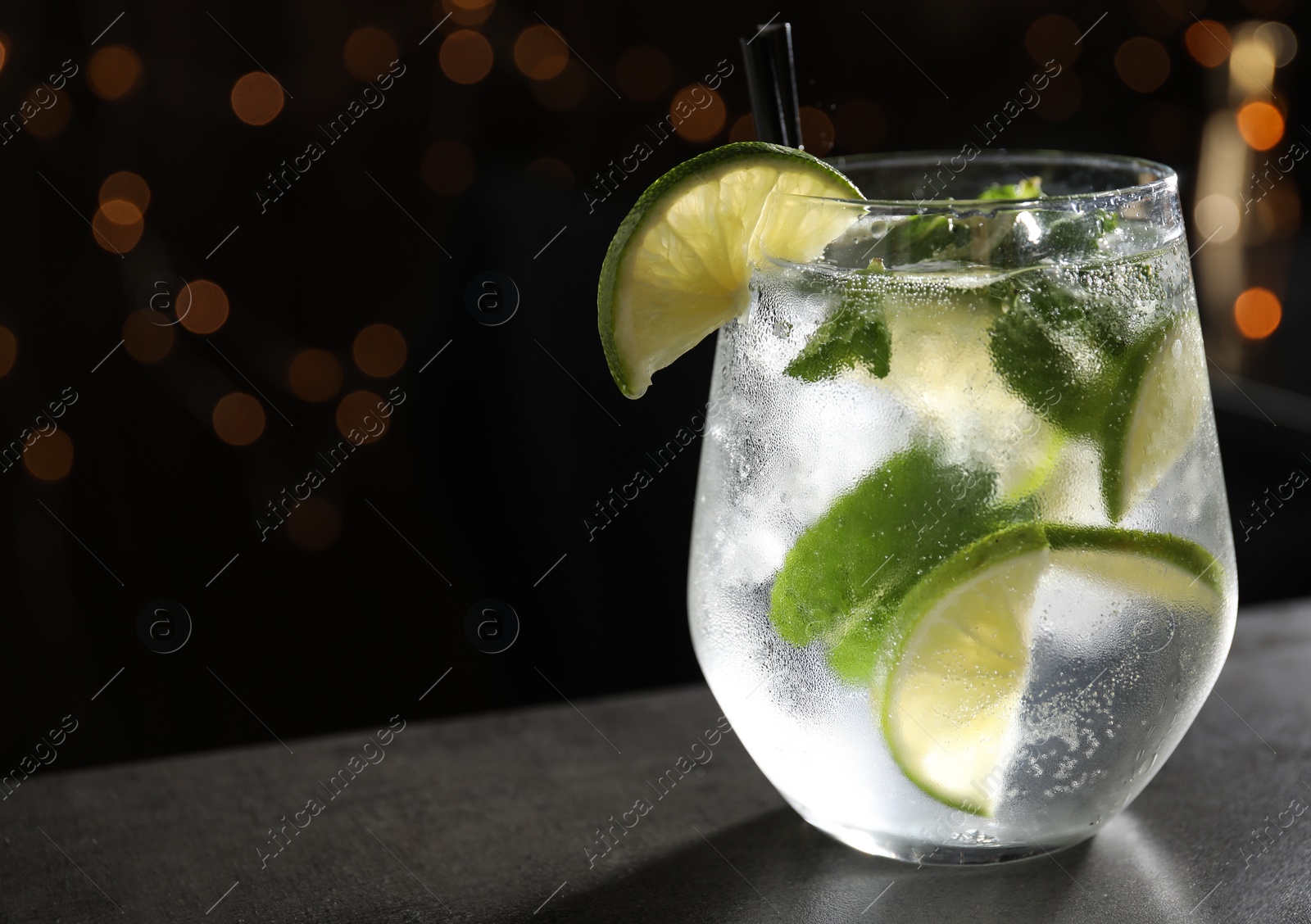 Photo of Glass of fresh alcoholic cocktail on bar counter, space for text