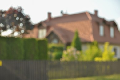 Blurred view of beautiful house and green shrubberies
