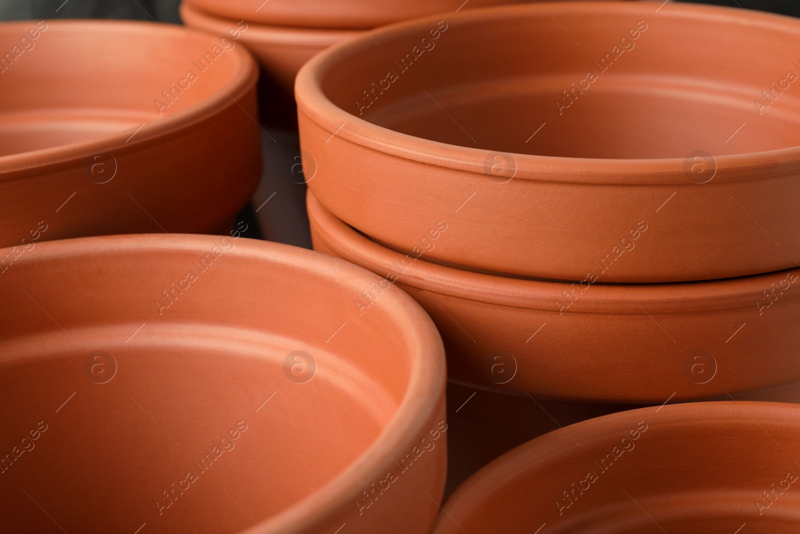 Photo of Many clay flower pots as background, closeup