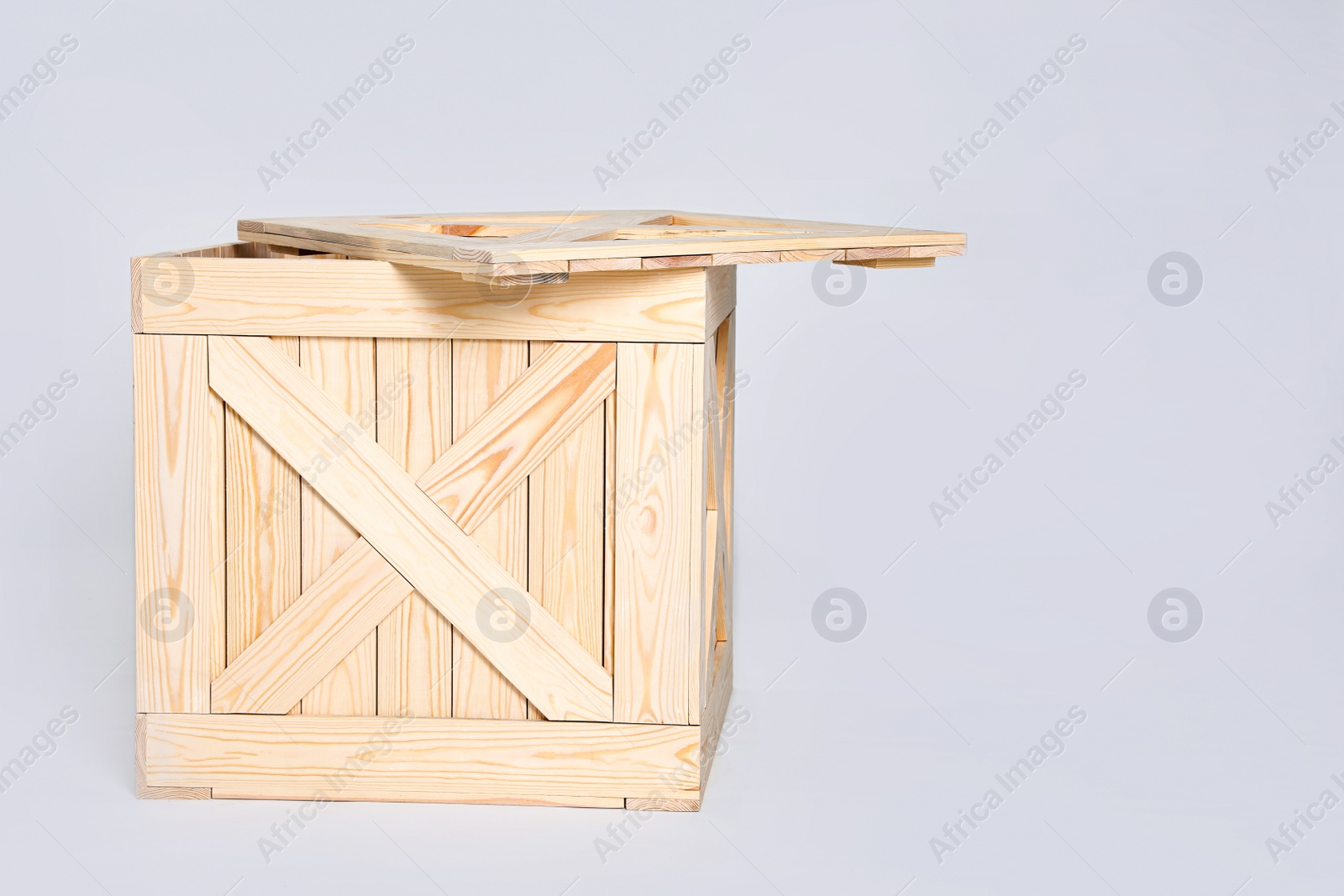 Photo of Open wooden crate on grey background. Space for text