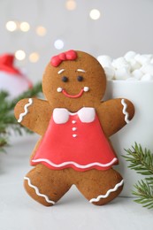 Photo of Gingerbread girl on light grey table, closeup