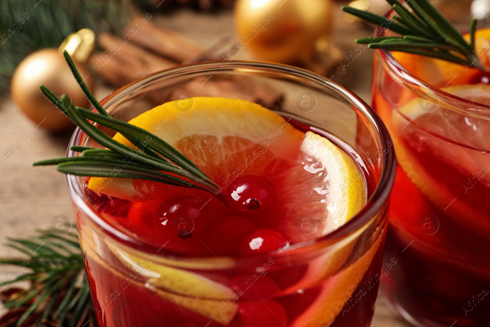 Photo of Glass with delicious punch drink on table, closeup