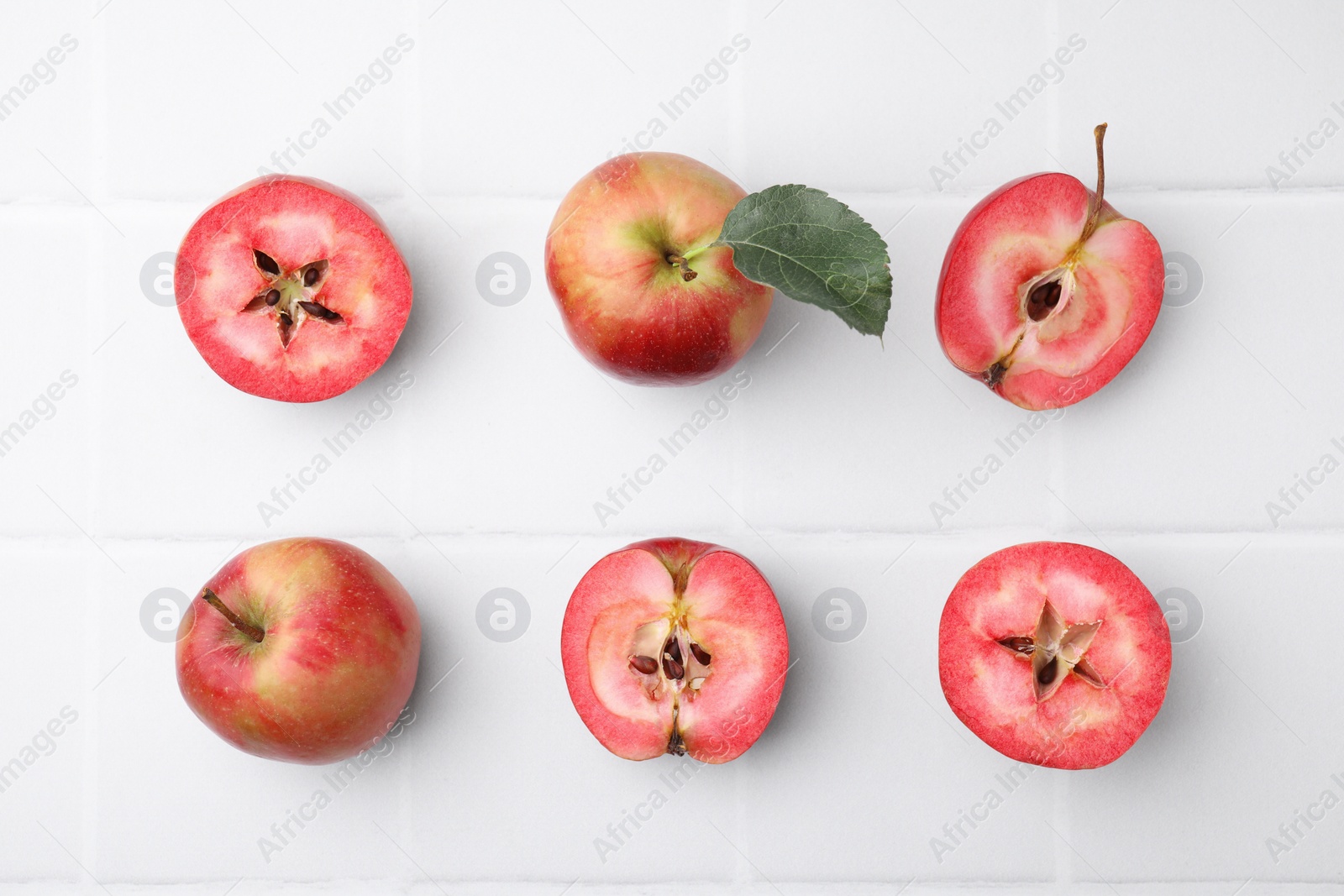 Photo of Tasty apples with red pulp on white background, flat lay