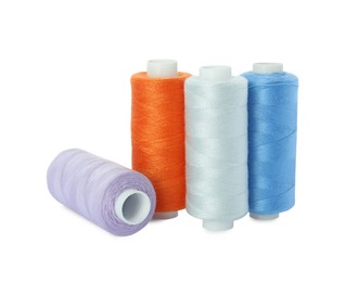 Many different colorful sewing threads on white background