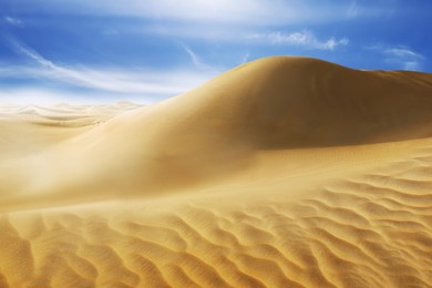 Picturesque view of sandy desert and blue sky on hot sunny day 