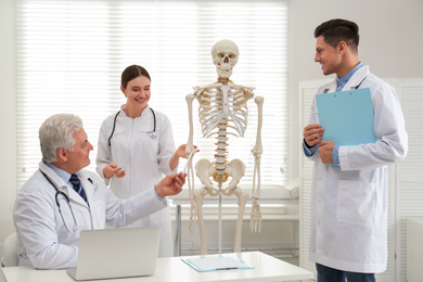 Photo of Professional orthopedist teaching medical students in clinic