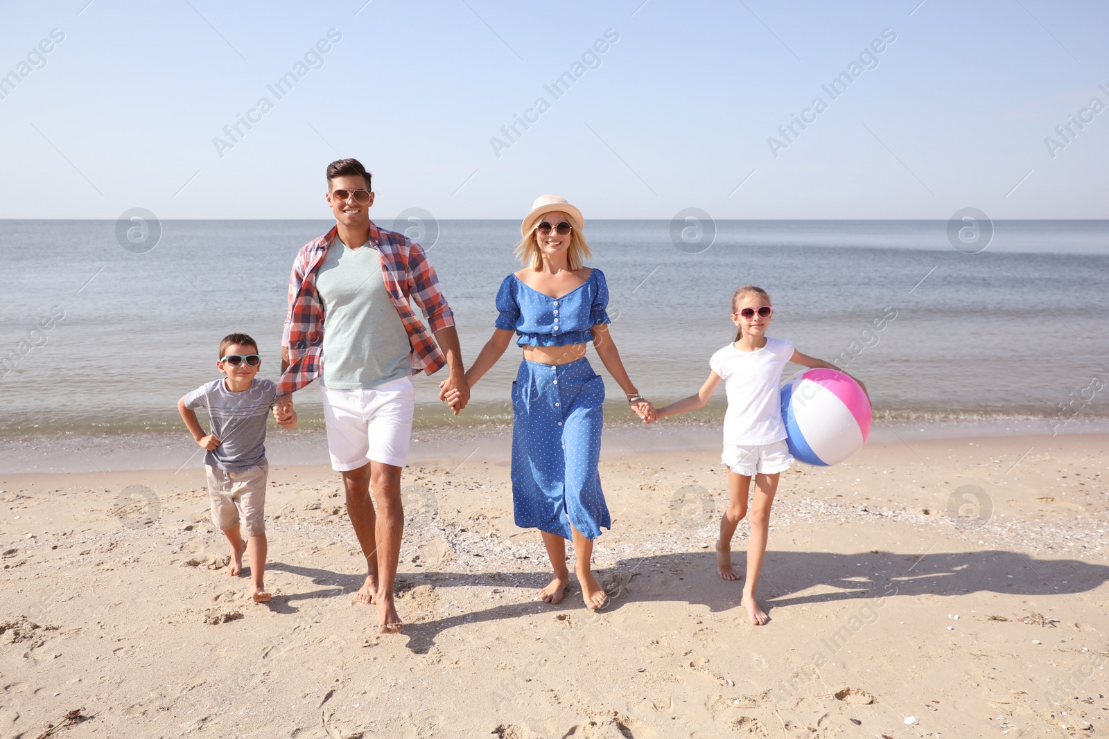 Photo of Happy family at beach on sunny summer day