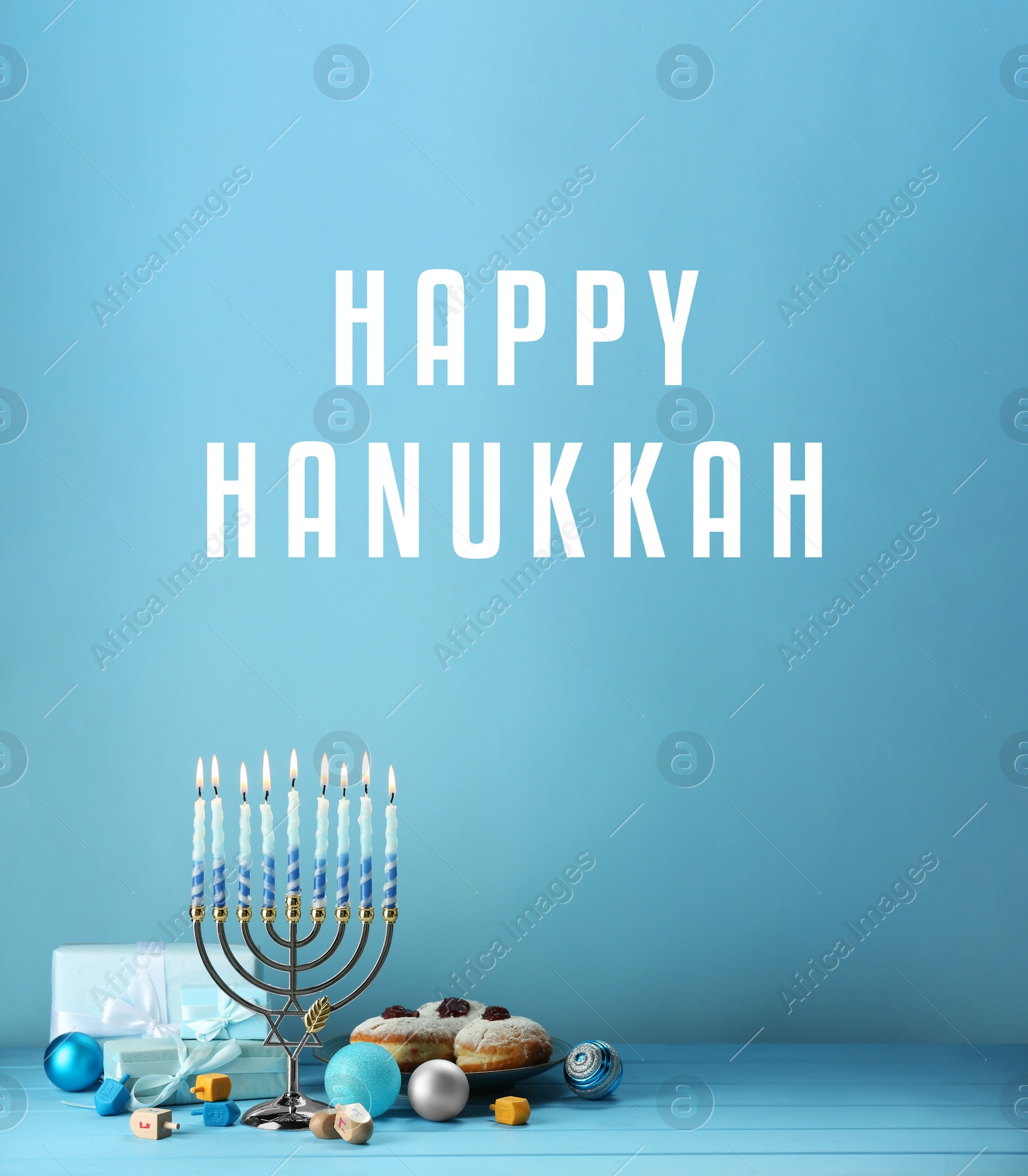 Image of Happy Hanukkah. Menorah, donuts, gifts and dreidels on light blue background