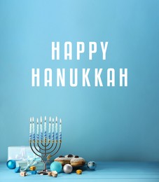 Image of Happy Hanukkah. Menorah, donuts, gifts and dreidels on light blue background