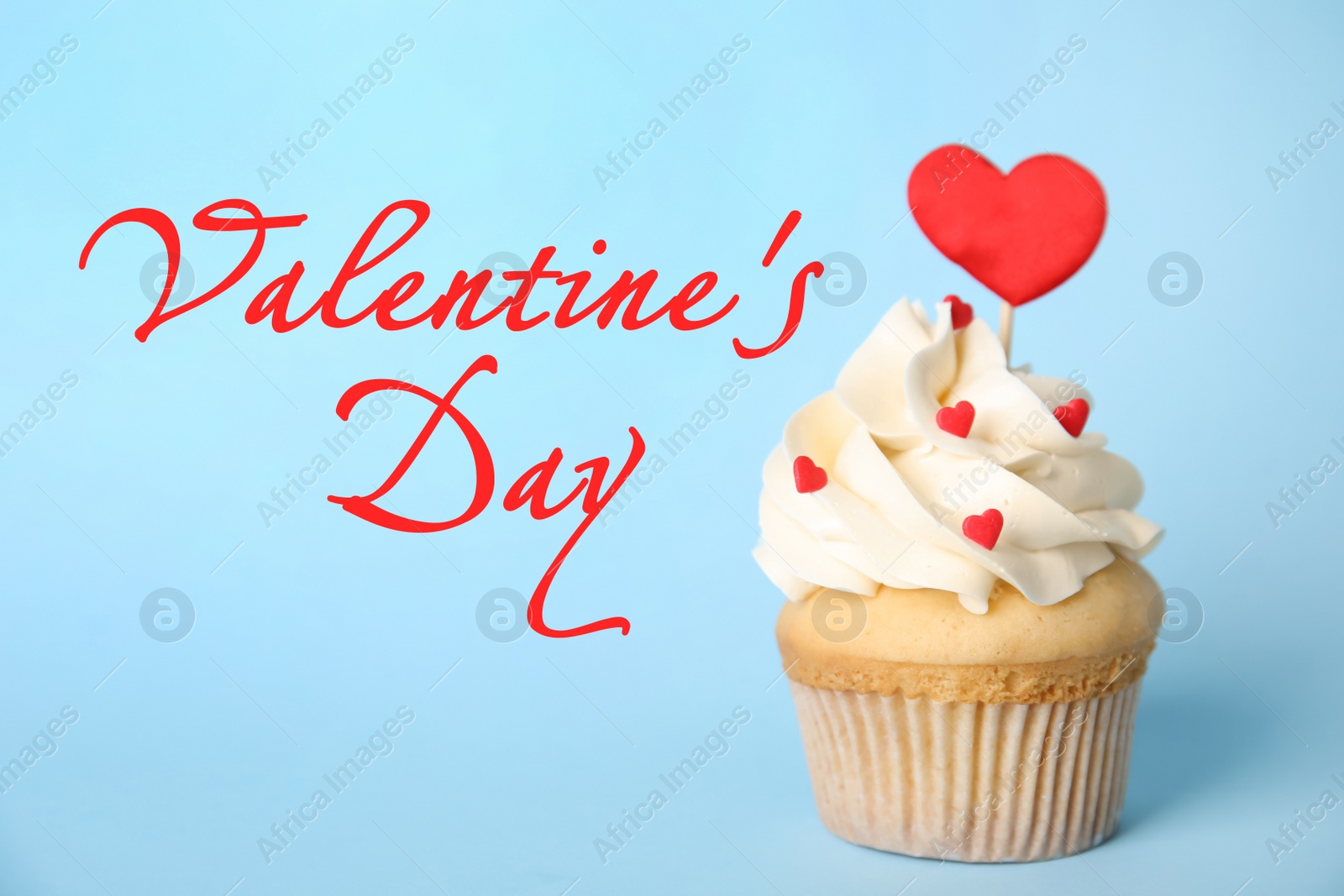 Image of Happy Valentine's Day. Tasty cupcake on light blue background 