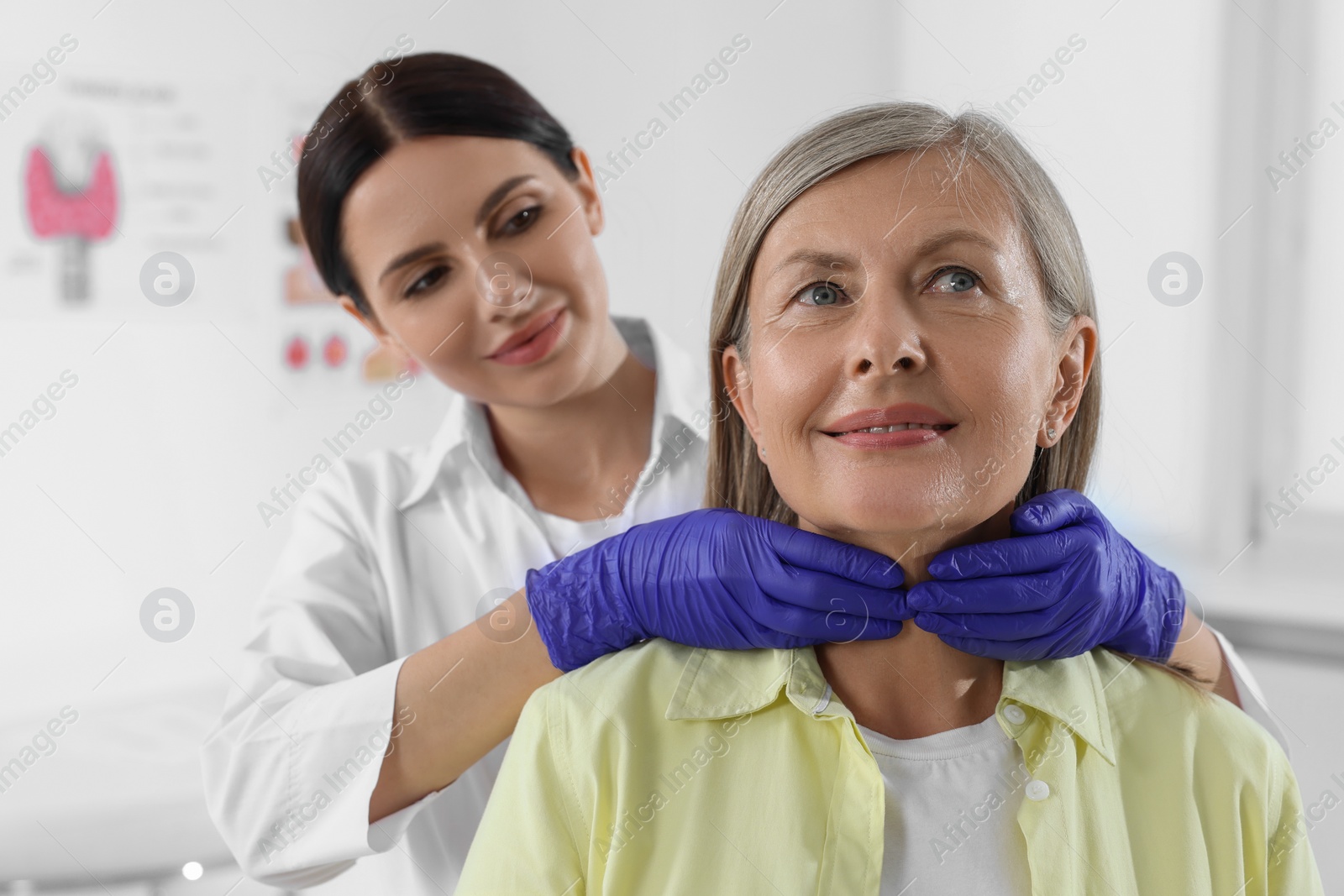 Photo of Endocrinologist examining thyroid gland of patient at hospital