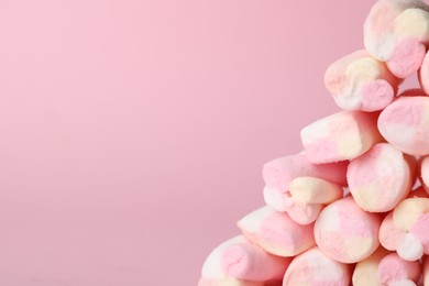 Stack of tasty marshmallows on pink background, closeup. Space for text