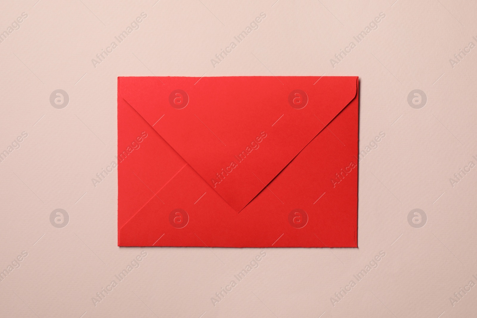 Photo of Letter envelope on beige background, top view