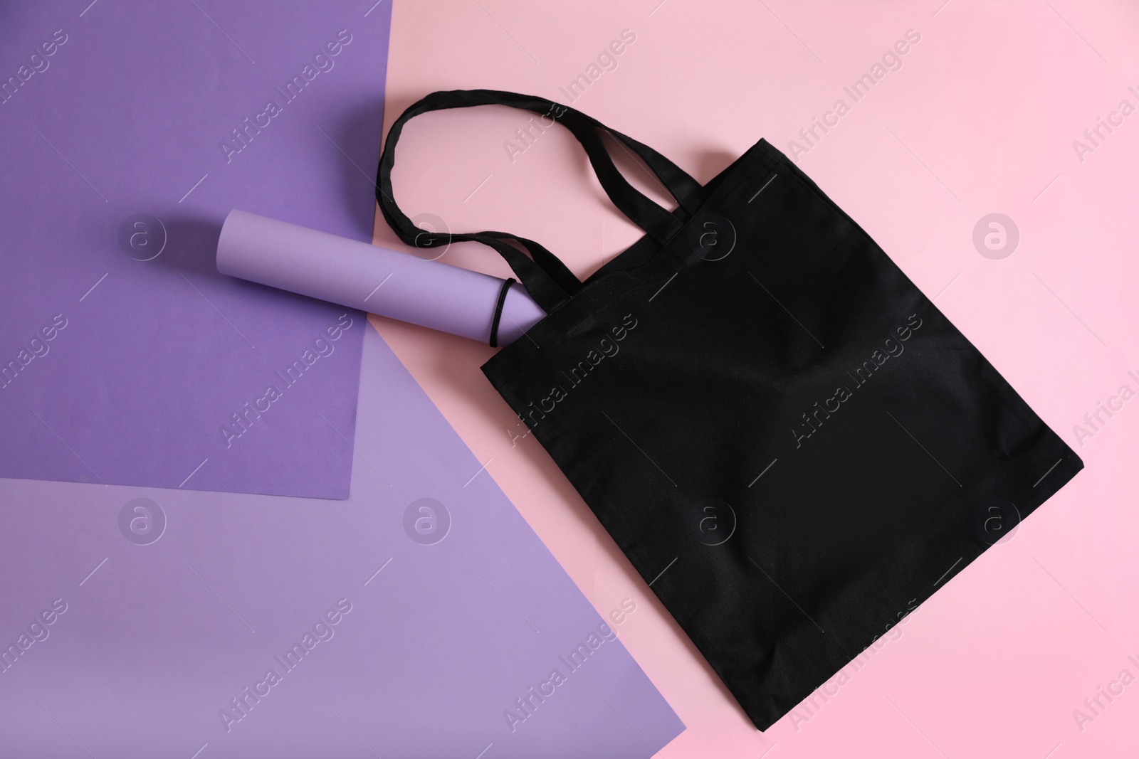 Photo of Flat lay composition with eco tote bag on color background. Space for design