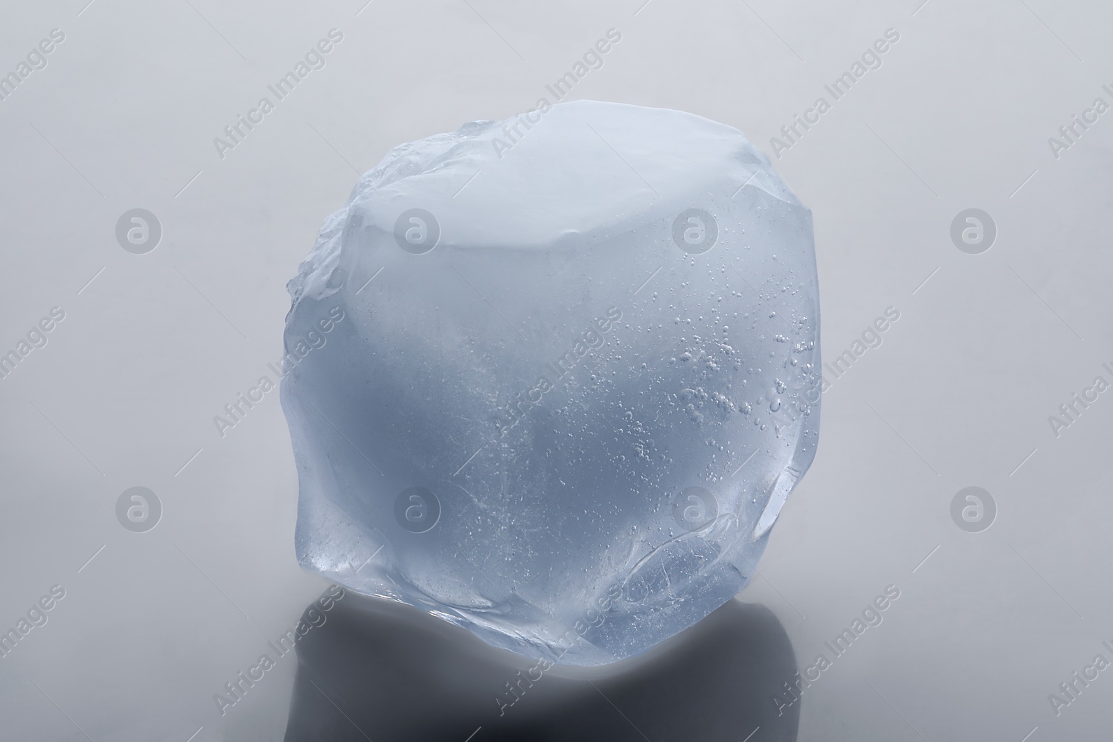 Photo of One crystal clear ice cube isolated on white