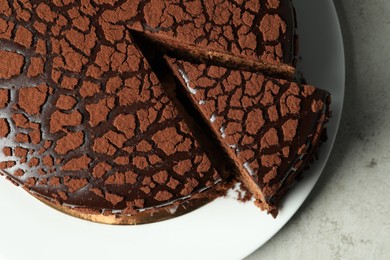 Photo of Delicious chocolate truffle cake on grey table, top view