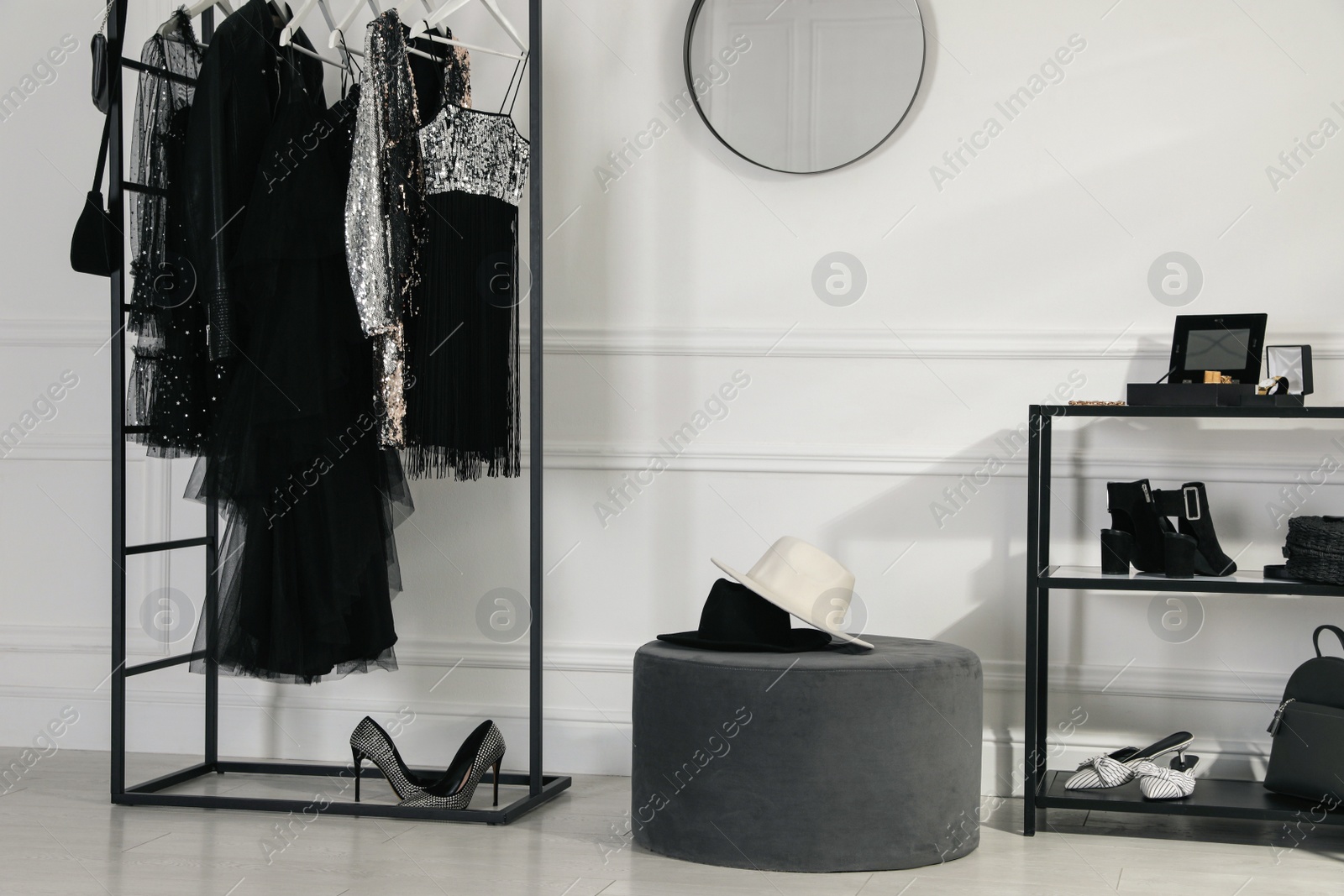 Photo of Stylish dressing room interior with trendy clothes, shoes and accessories