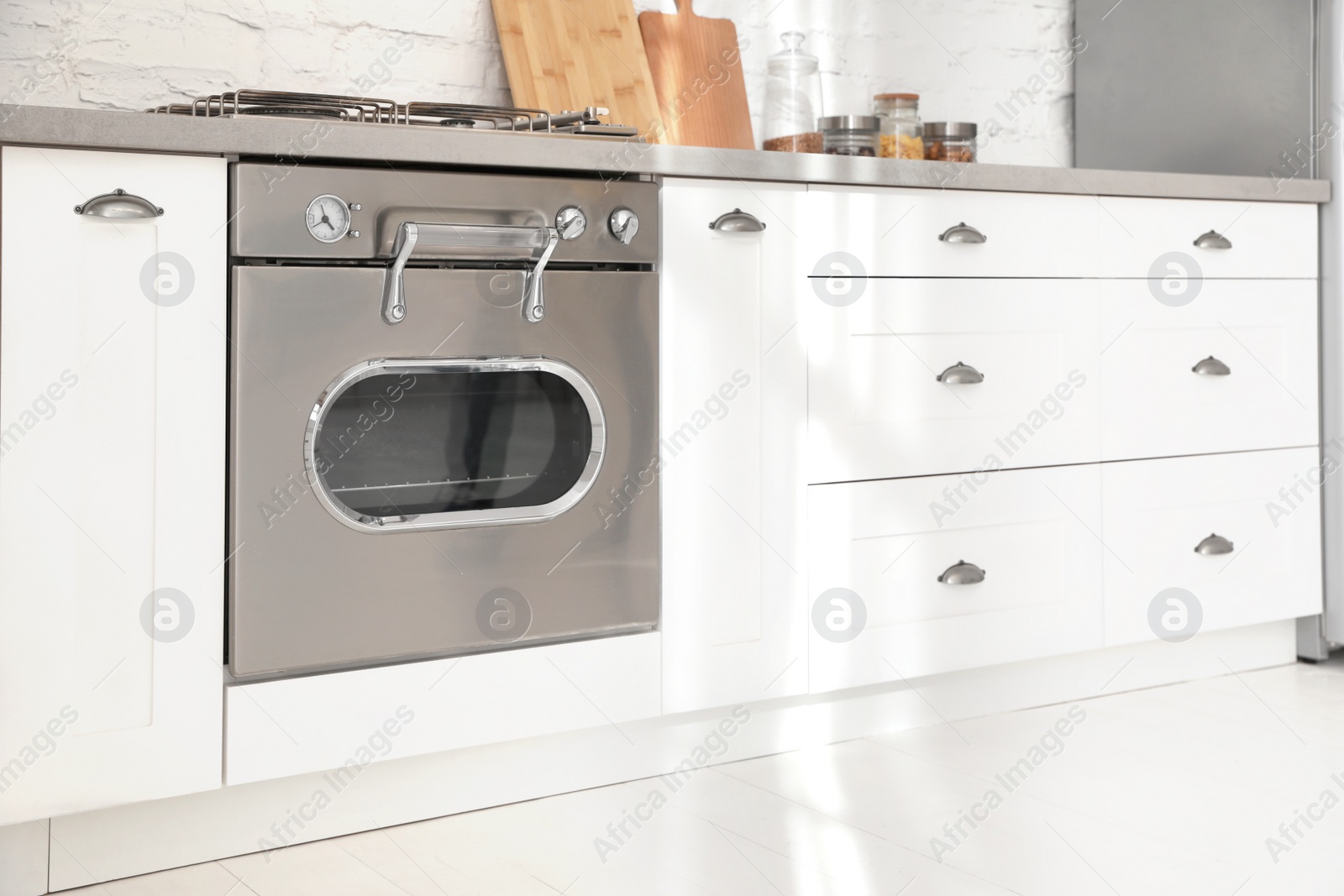 Photo of New modern oven in stylish kitchen. Cooking appliance