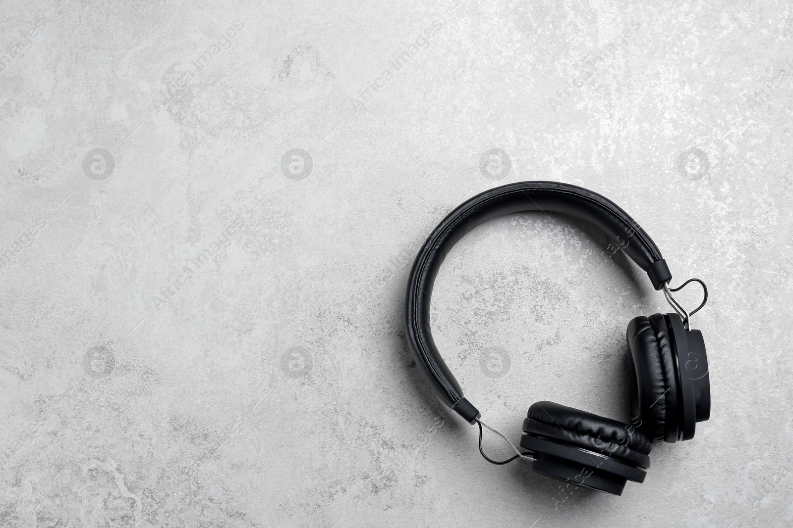 Photo of Stylish headphones on grey background, top view. Space for text