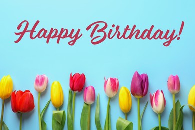 Image of Happy Birthday! Beautiful tulips on light blue background, flat lay