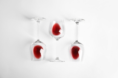 Composition with glasses of wine on white background, top view