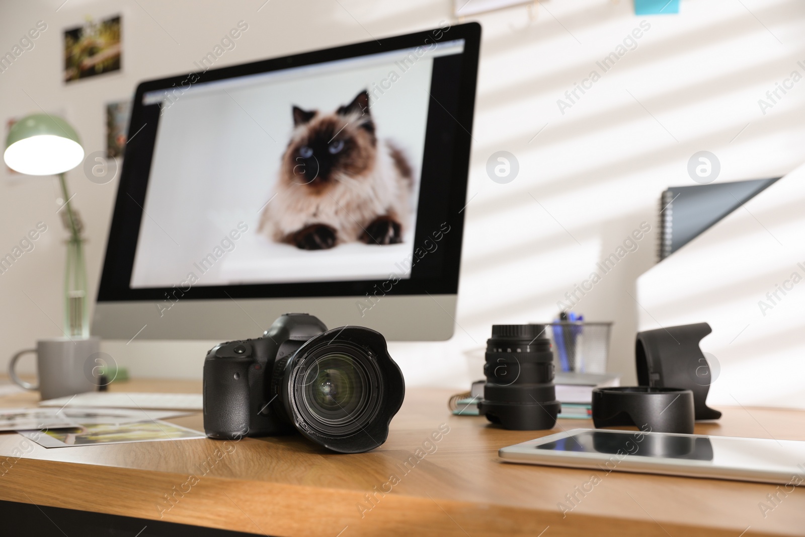 Photo of Photographer's workplace with professional camera in office