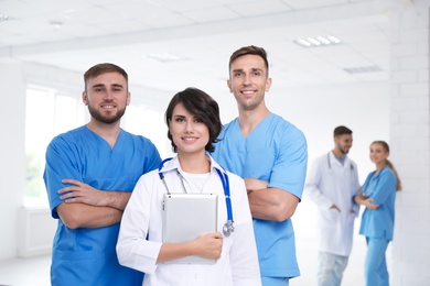 Photo of Team of doctors with tablet at workplace