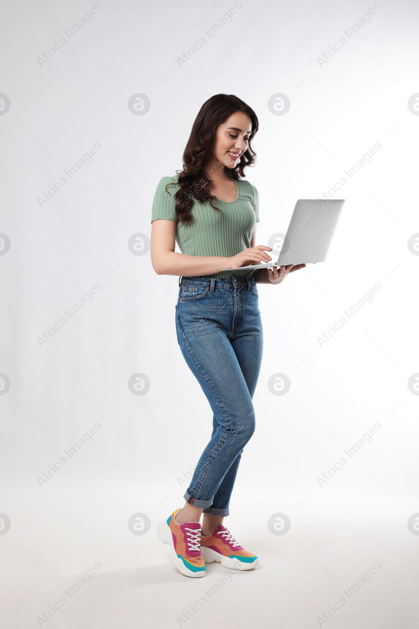 Photo of Young woman with laptop on white background