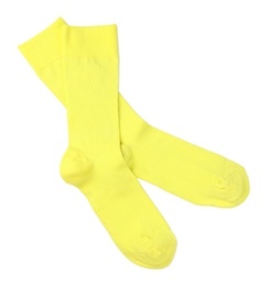 Photo of Yellow socks on white background, top view