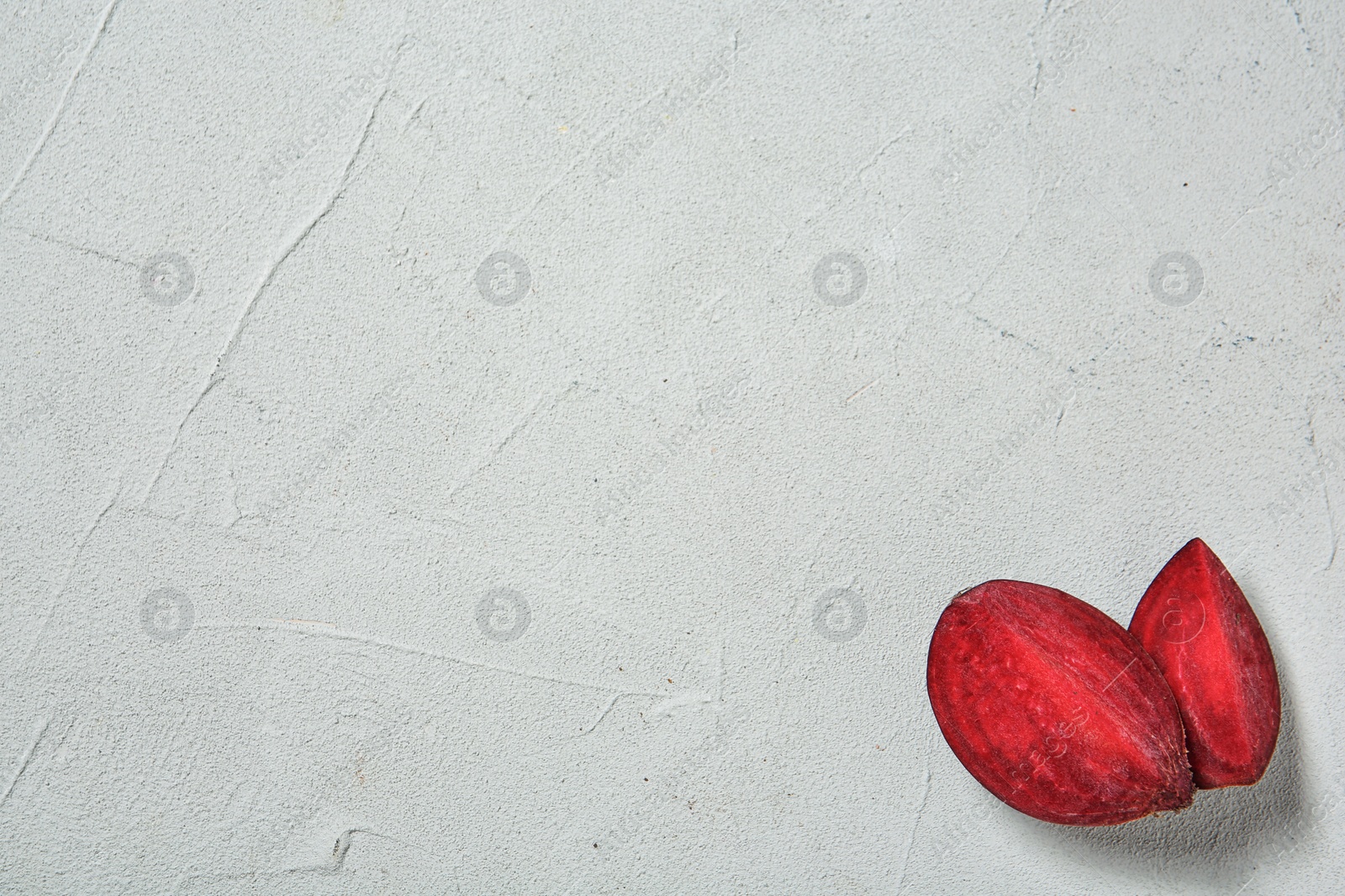 Photo of Ripe beet slices on light background with space for text, top view