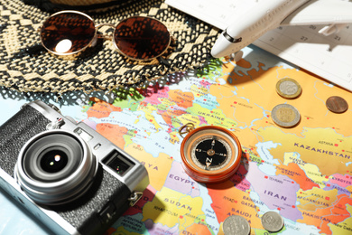 Photo of Different items on world map. Travel during summer vacation