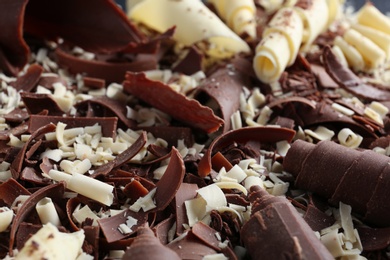 Photo of Yummy chocolate curls for decor as background, closeup