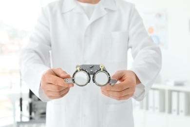 Ophthalmologist with trial frame in clinic, closeup